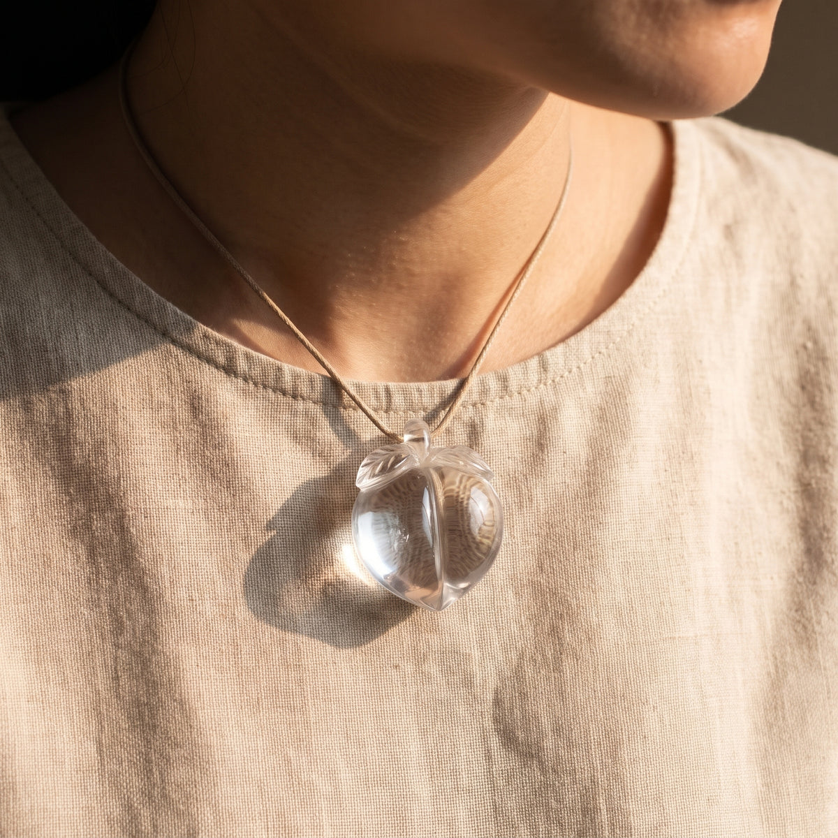 Clear Quartz Peach Charm – Long Life & Warding — display at home